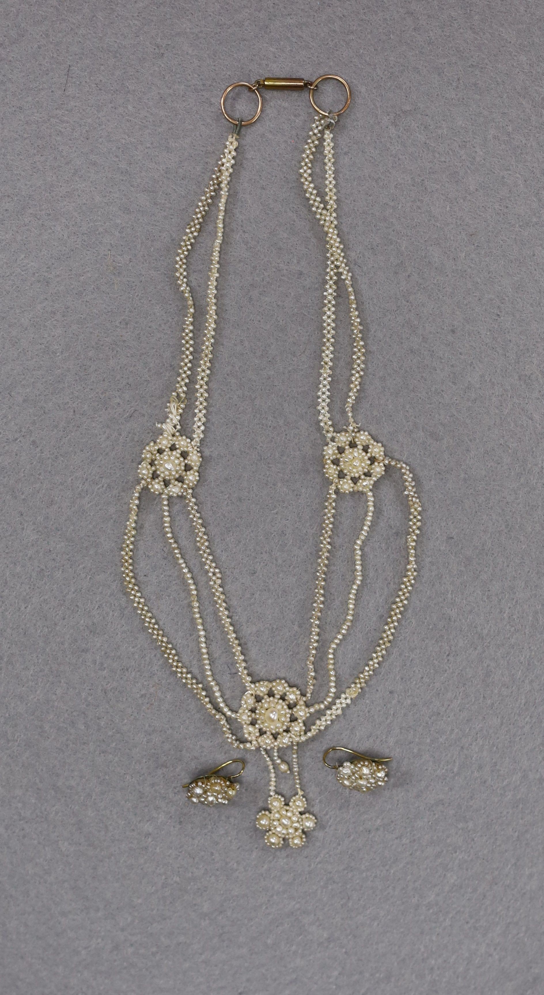 A 19th century multi strand seed pearl necklace, 40cm and a pair of similar earrings.